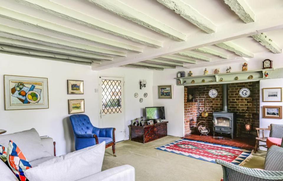 News Shopper: One of the three reception rooms has an 'inglenook' fireplace, with the original bread oven still intact