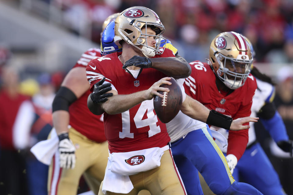 San Francisco 49ers quarterback Sam Darnold (14) is sacked by Los Angeles Rams linebacker Byron Young during the second half of an NFL football game in Santa Clara, Calif., Sunday, Jan. 7, 2024. (AP Photo/Jed Jacobsohn)