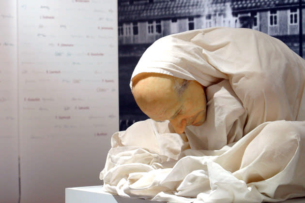 "Man with Sheet" created by Australian artist Ron Mueck crouches silently as a testiment to the medical professions shame at the Medical History Museum April 29, 2003 in Berlin. A new exhibition, "Unscrupulous and Scrupulous," questions the legitimacy of medical experiments by Nazi Doctors by bringing examples to Berlin. Experts believe that there were 8,000 to 10,000 victims of the Nazi medical experiments, but only 20 to 25 percent have been identified despite continued investigations. The exhibition shows some of the treatments the victims endured, including decompression experiments on Russian captives and Auschwitz's ''Angel of Death'' Josef Mengele's fascination with twins. (Photo by Kurt Vinion/Getty Images)