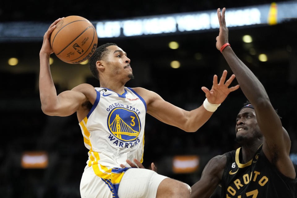 Toronto Raptors forward Pascal Siakam tries to stop Golden State Warriors guard Jordan Poole (3) from going to the net during the second half of an NBA basketball game in Toronto, Sunday, Dec. 18, 2022. (Frank Gunn/The Canadian Press via AP)