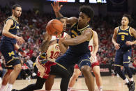 Nebraska's Jamarques Lawrence, center left, passes the ball around Michigan's Tarris Reed Jr., center right, during the first half of an NCAA college basketball game Saturday, Feb. 10, 2024, in Lincoln, Neb. (AP Photo/Rebecca S. Gratz)