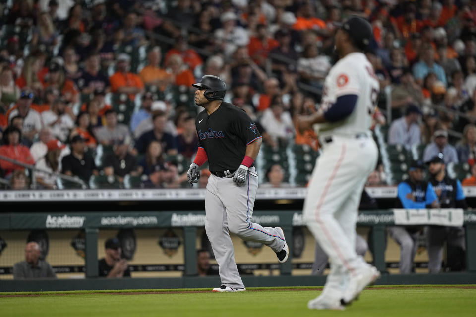 Miami Marlins' Jesus Aguilar, left, scores from third base after a bases loaded walk by Houston Astros starting pitcher Framber Valdez, right, during the second inning of a baseball game Saturday, June 11, 2022, in Houston. (AP Photo/David J. Phillip)