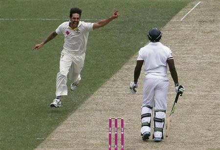 Australia's Mitchell Johnson (C) celebrates taking the wicket of England's Michael Carberry (R) for a duck during the first day of the fifth Ashes cricket test at the Sydney cricket ground January 3, 2014. REUTERS/David Gray