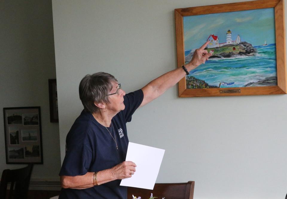 Norma Clark, owner of Norma's Restaurant, points out the room at the Nubble Lighthouse where her mother was born and her great grandfather being the lighthouse keeper.