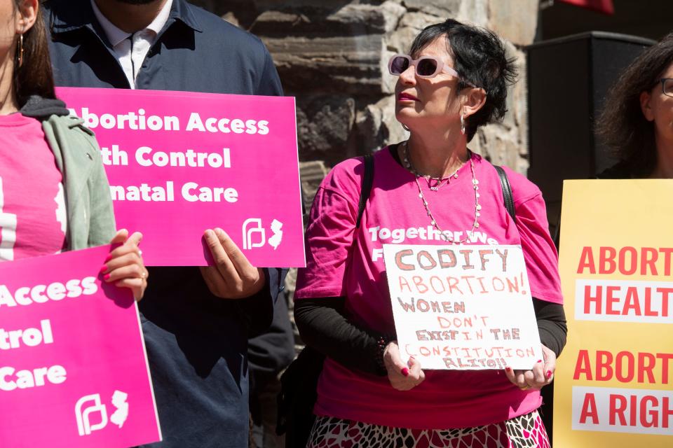 Monica Taylor, who serves on the board of Planned Parenthood of Metropolitan New Jersey, holds a sign during a pro-Roe rally, which brought lawmakers and abortion rights activists to the Rutgers-Newark campus on Monday, May 9, 2022.