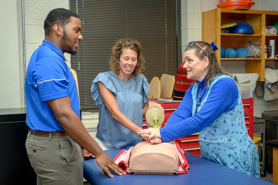 Helen Binkley, right, director of the Athletic Training master’s program at Middle Tennessee State University, and Kristi Phillips, the program’s coordinator, demonstrate a CPR technique to then student Nick Smith, now an MTSU graduate, in the summer of 2021 on campus.