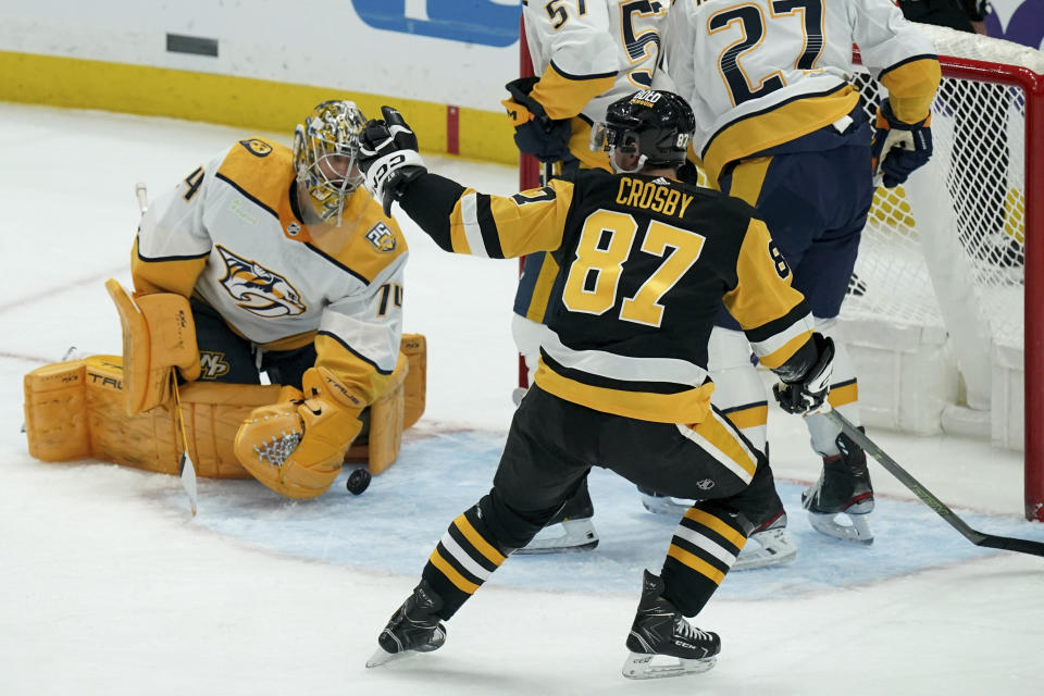 Pittsburgh Penguins' Sidney Crosby (87) celebrates after scoring against Nashville Predators goaltender Juuse Saros (74) during the first period of an NHL hockey game, Monday, April 15, 2024, in Pittsburgh. (AP Photo/Matt Freed)