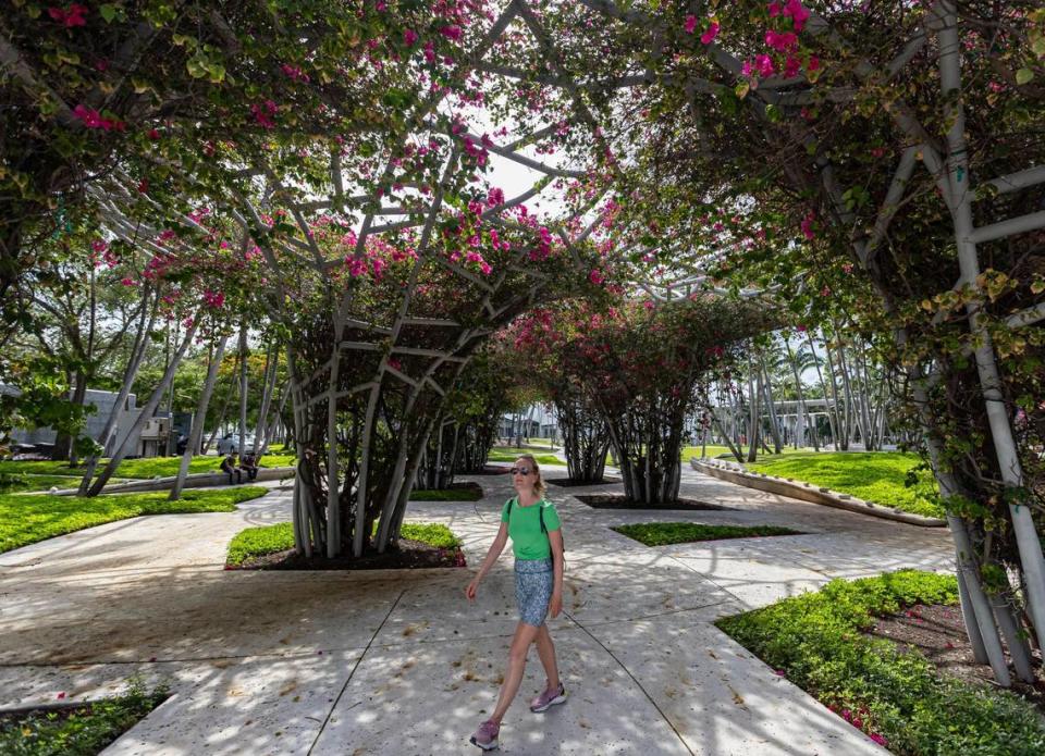 Tatiana Soboleva, a tourist from Paris, France, walks through Soundscape Park in Miami Beach on Wednesday, June 21, 2023. Two of developer Michael Shvo’s office building projects will face Soundscape Park, the popular venue for films and concerts by the New World Synmphony. MATIAS J. OCNER/mocner@miamiherald.com
