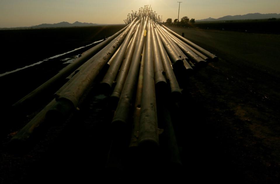 Irrigation pipes and sprinklers sit on a trailer at the side of a road in Blythe.