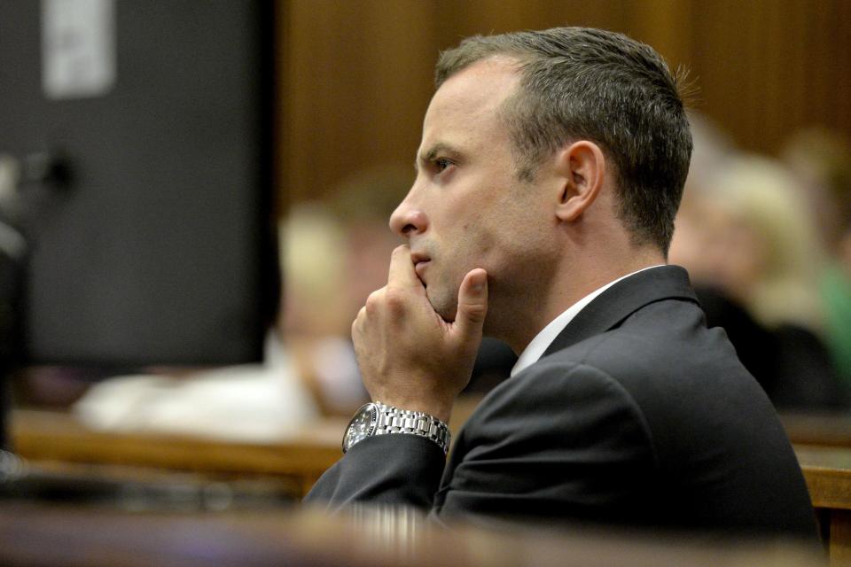 Olympic and Paralympic track star Oscar Pistorius sits in the dock during Pistorius' trial for the murder of his girlfriend Reeva Steenkamp, at the North Gauteng High Court in Pretoria, March 3, 2014. The first witness at Pistorius' murder trial told the court on Monday she heard "bloodcurdling screams" from a woman followed by shots, a dramatic opening to a case that could see one of global sports' most admired role models jailed for life. Pistorius pleaded not guilty to murdering model Steenkamp on Valentine's Day last year. REUTERS/Themba Hadebe/Pool (SOUTH AFRICA - Tags: SPORT ATHLETICS ENTERTAINMENT CRIME LAW)