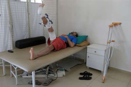 Saleh Othman, 27, who was wounded in Syria, rests on a bed inside a hospital in Tripoli, Lebanon May 23, 2017. Picture taken May 23, 2017.REUTERS/Mohamed Azakir