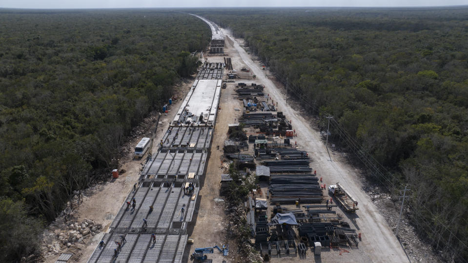 Workers build a Maya Train railway track near Playa del Carmen, Mexico, Sunday, March 10, 2024. When it's completed, the high-speed Maya Train will wind around Mexico's southern Yucatan peninsula. (AP Photo/Rodrigo Abd)