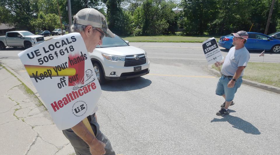 Tim Van Tassel, 62, left, and Phil Bryan, 54, members of the United Electrical, Radio and Machine Workers of America, walk a picket line at the Wabtec Corp. on Wednesday.