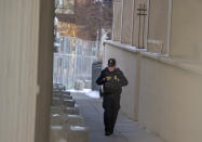 A security officer patrols the gated Warren E. Burger Federal Building as jury selection begins in the trial of ex-Minneapolis officers charged in the George Floyd killing in St. Paul, Minn., Thursday, Jan. 20, 2021. Jury selection began Thursday in the federal trial of three Minneapolis police officers charged in George Floyd’s killing, with the judge stressing repeatedly that fellow Officer Derek Chauvin's conviction on state murder charges and guilty plea to a federal civil rights violation should not influence the proceedings. (Elizabeth Flores/Star Tribune via AP)