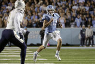 North Carolina quarterback Drake Maye (10) evades Georgia Tech linebacker Charlie Thomas (1) as he runs upfield during the first half of an NCAA college football game, Saturday, Nov. 19, 2022, in Chapel Hill, N.C. (AP Photo/Chris Seward)