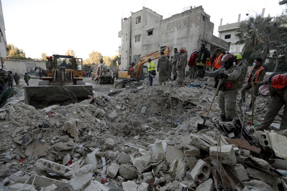 Rescue workers search for survivor on a collapsed building in the coastal city of Latakia, Syria, Thursday, Feb. 9, 2023. The quake that razed thousands of buildings was one of the deadliest worldwide in more than a decade. (AP Photo/Omar Sanadiki)