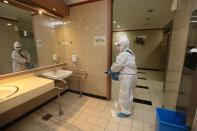 Employees from a disinfection service company sanitize the National Assembly in Seoul