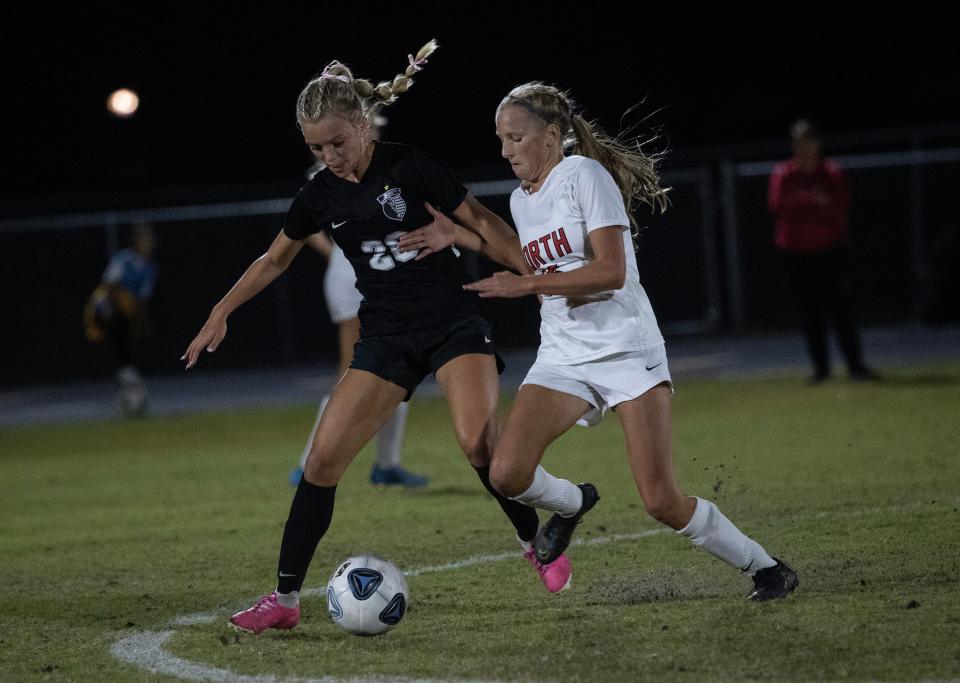 Ryleigh Acosta of Mariner and Lexi Neumann of North Fort Myers fight for possession on Tuesday, Dec. 12, 2023, at Mariner High School in Cape Coral.