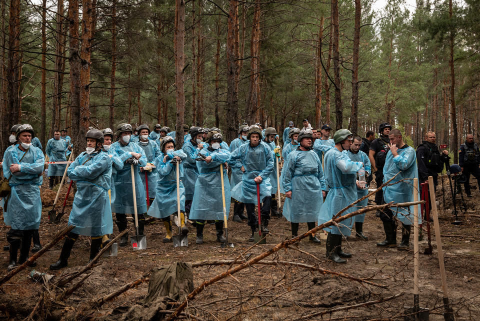 Investigators exhume the bodies at a site of 445 mostly unmarked graves, as well as one mass grave in Izium, Ukraine, on Sept. 16, 2022.<span class="copyright">Nicole Tung</span>