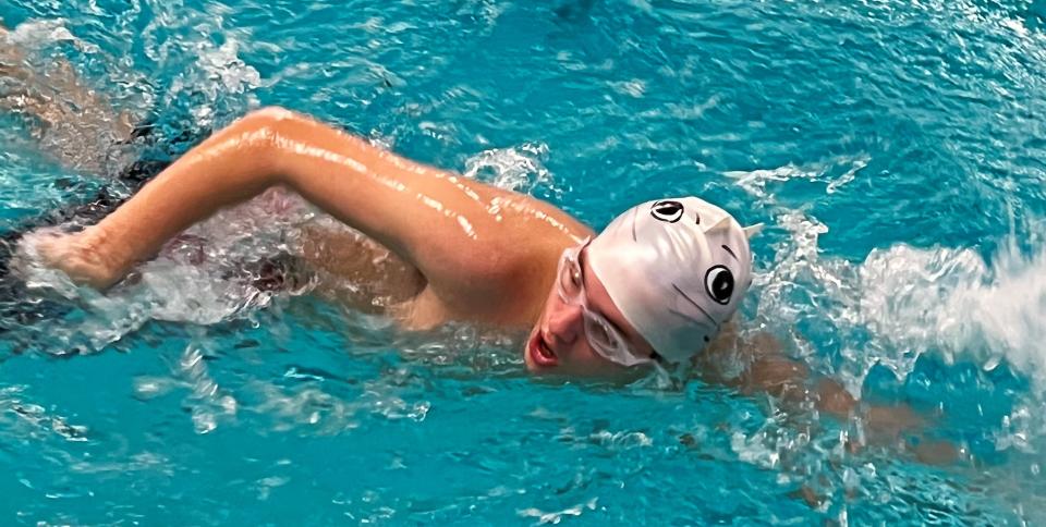 Aidan Christy competes with his luck swim cap.