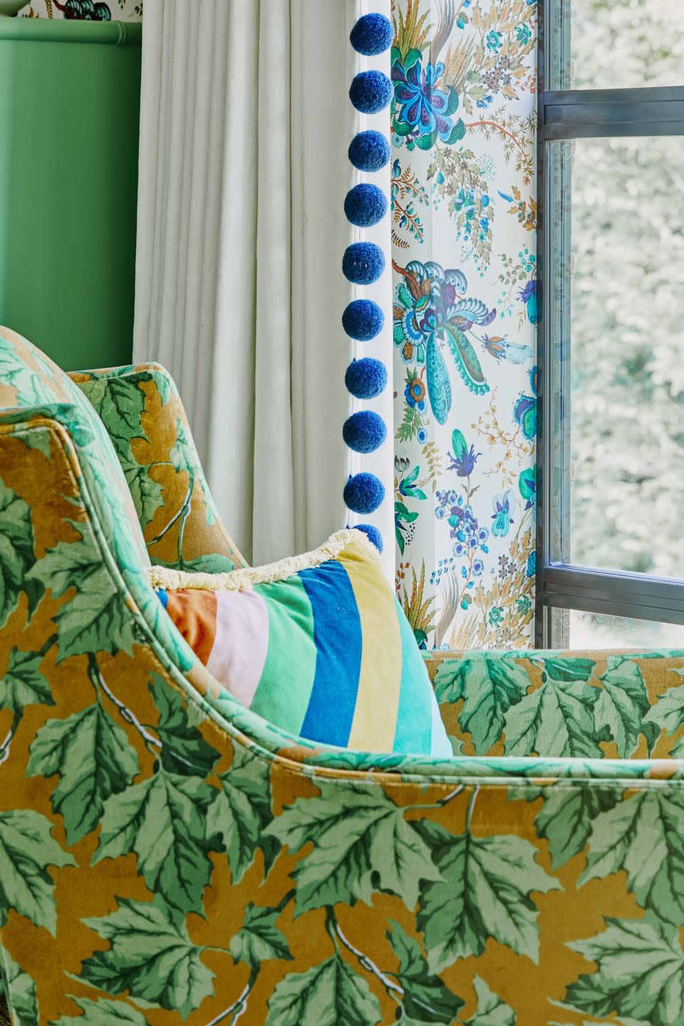 a colourful pattern clash maximalist bedroom with a bed and a chair