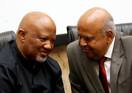 FILE PHOTO: South Africa's outgoing Finance Minister Pravin Gordhan (R) chats with Deputy Minister Mcebisi Jonas during a media briefing at their offices in Pretoria, South Africa, March 31, 2017. REUTERS/Siphiwe Sibeko