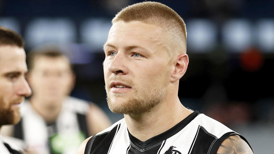 Pictured here, Jordan De Goey looks on after an AFL game for Collingwood in 2021.