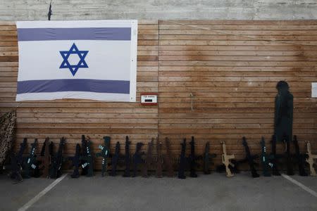 An Israeli flag and wooden cut-out rifles are seen during a two hour "boot camp" experience, at "Caliber 3 Israeli Counter Terror and Security Academy " in the Gush Etzion settlement bloc south of Jerusalem in the occupied West Bank July 13, 2017. Picture taken July 13, 2017. REUTERS/Nir Elias