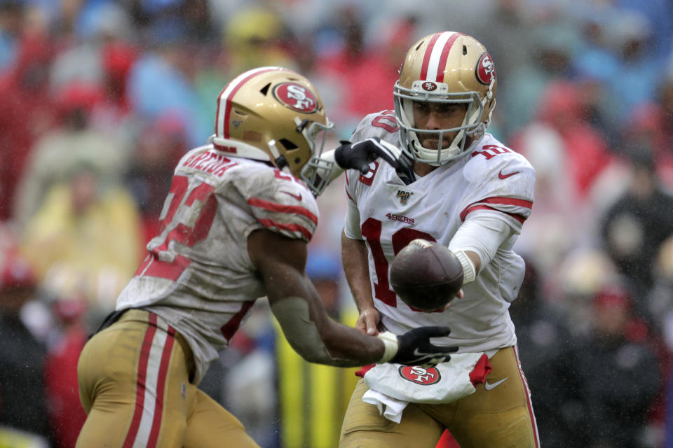 San Francisco 49ers quarterback Jimmy Garoppolo, right, hands off the ball to running back Matt Breida in the second half of an NFL football game against the Washington Redskins, Sunday, Oct. 20, 2019, in Landover, Md. (AP Photo/Julio Cortez)