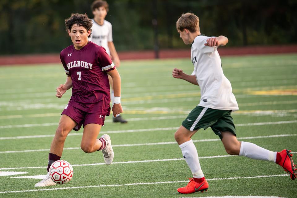 Millbury's Cole Galicia pushes up the field as Bartlett's Eryk Piwowarczyk defends during Wednesday's game.