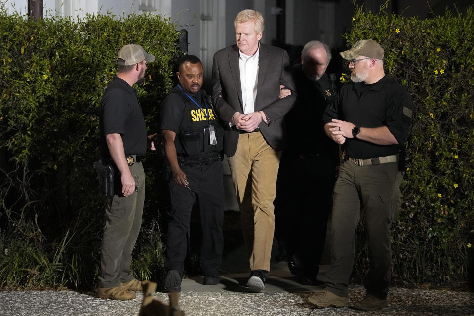 Alex Murdaugh , center, is led out of Colleton County Courthouse by sheriff's deputies after being convicted Thursday, March 2, 2023, in Walterboro, S.C. Murdaugh was found guilty Thursday on two counts of murder in the shooting deaths in June 2021 of his wife and son. (AP Photo/Chris Carlson)