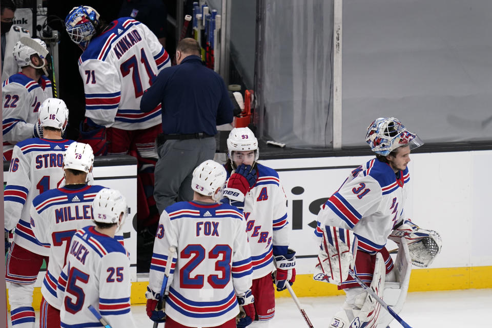 New York Rangers goaltender Keith Kinkaid (71) heads to the locker room after an apparent injury as goaltender Igor Shesterkin (31) skates to the crease during the third period of an NHL hockey game against the Boston Bruins, Saturday, May 8, 2021, in Boston. (AP Photo/Charles Krupa)