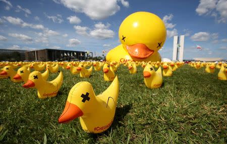 Inflatable dolls in the shape of ducks are seen in front of the National Congress during a protest against tax increases in Brasilia, Brazil, March 29, 2016. REUTERS/Gregg Newton