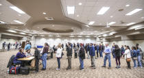 Voters line up to cast the ballots soon after the polls opened at the Oxford Conference Center in Oxford, Miss., Tuesday, Nov. 5, 2019. (Bruce Newman/The Oxford Eagle via AP)