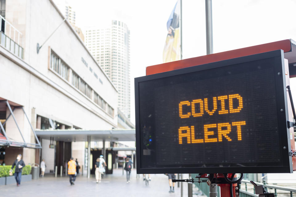 A concept to illustrate the daily impact of the Covid-19 virus on the public as a whole. A static sign displays messaging regarding the pandemic.