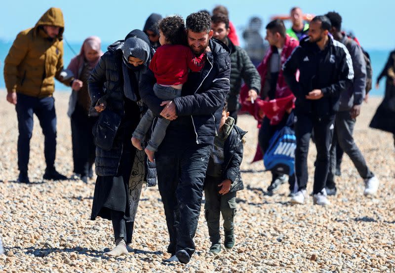 FILE PHOTO: People, believed to be migrants, arrive in Dungeness