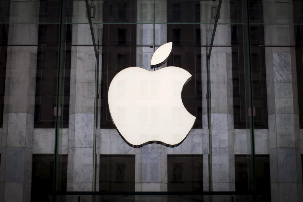 Apple logo hangs above entrance to Apple store