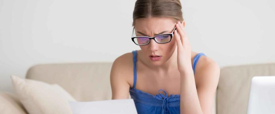 Worried woman reading negative news in letter,