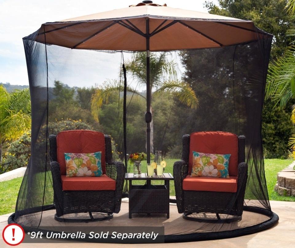 Outdoor patio set with seating and a bug net canopy, text highlights protection from insects. Note: Umbrella sold separately