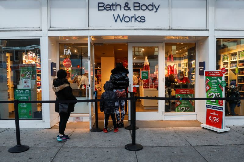 Shoppers wait in line outside a Bath and Body Works retail store, as the global outbreak of the coronavirus disease (COVID-19) continues, in Brooklyn, New York