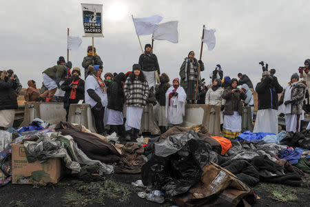 Women hold a demonstration on Backwater Bridge during a protest against plans to pass the Dakota Access pipeline near the Standing Rock Indian Reservation, near Cannon Ball, North Dakota, U.S. November 27, 2016. REUTERS/Stephanie Keith