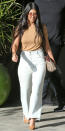 <p>Kardashian showed that wide-leg jeans are back in style in a pair of frayed white-wash denim (shop a similar style <a rel="nofollow noopener" href="http://us.topshop.com/en/tsus/product/moto-panel-insert-cropped-wide-6328445?bi=0&ps=20&Ntt=wide%20jeans" target="_blank" data-ylk="slk:here;elm:context_link;itc:0;sec:content-canvas" class="link ">here</a>) after filming <i>Keeping Up with the Kardashians </i>in Calabasas, Calif. She elevated the look with a brown tee and matching suede pumps, ensuring that the wide jeans didn’t overwhelm her petite frame.</p>