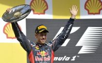 Red Bull Racing's German driver Sebastian Vettel celebrates on the podium at the Spa-Francorchamps circuit in Spa during the Belgium Formula One Grand Prix. Jenson Button claimed his second win this year and 14th of his career when he drove to a comprehensive victory in an incident and accident-packed Belgian Grand Prix