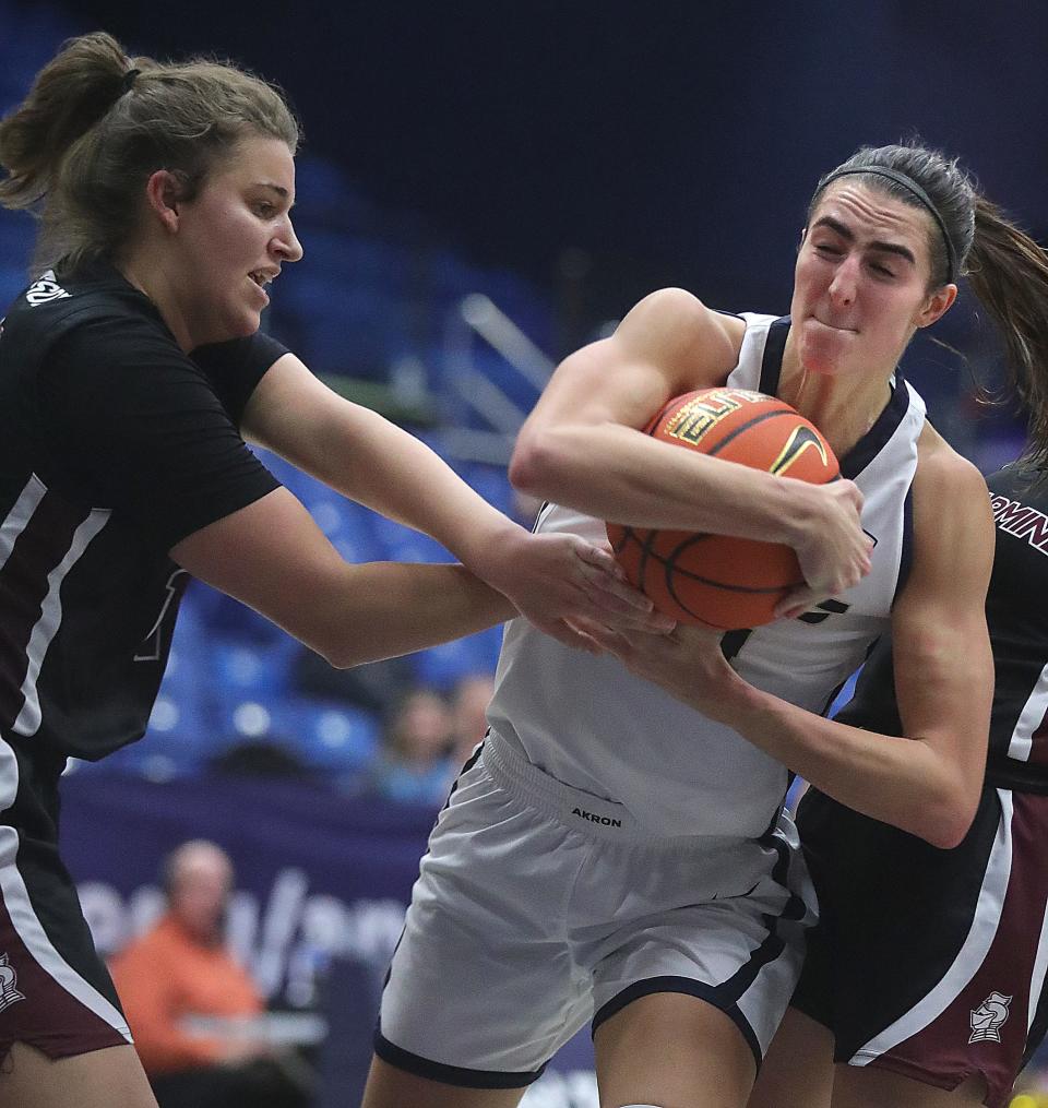 University of Akron's Reagan Bass wrestles a rebound away from Bellarmine's Lucy Robertson on Thursday in Akron.