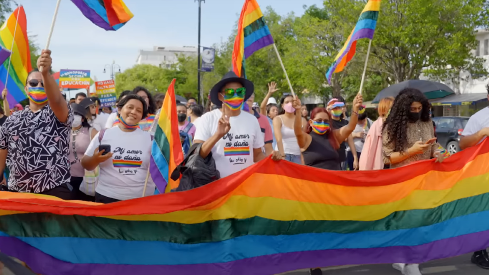 People marching in a Pride parade in Queer Planet