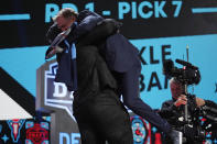 Alabama offensive lineman JC Latham embraces NFL Commissioner Roger Goodell, right, after being chosen by the Tennessee Titans with the seventh overall pick during the first round of the NFL football draft, Thursday, April 25, 2024, in Detroit. (AP Photo/Jeff Roberson)