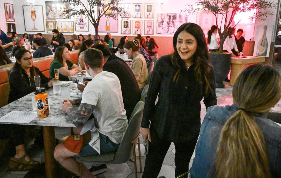 Mary Boursalyan, co-owner of The Brunch Bar in Clovis, checks with guests during a test run of her restaurant on Tuesday, May 9, 2023.