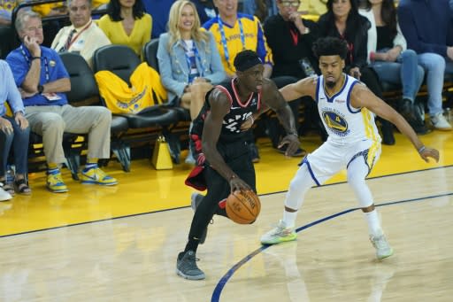 Golden State Warriors minority investor Mark Stevens, seated in blue shirt at left, was issued a one-year NBA ban and fined $500,000 after shoving Toronto's Kyle Lowry in game three of the NBA Finals