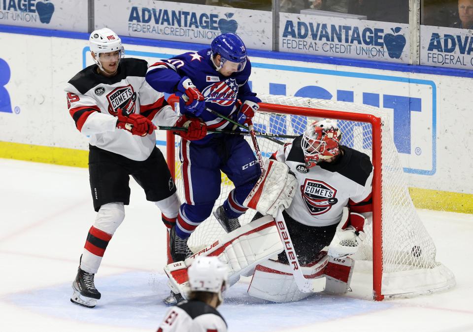 The Amerks' Brandon Biro redirects a shot past Utica goalie Akira Schmid.  Rochester won in OT 4-3.