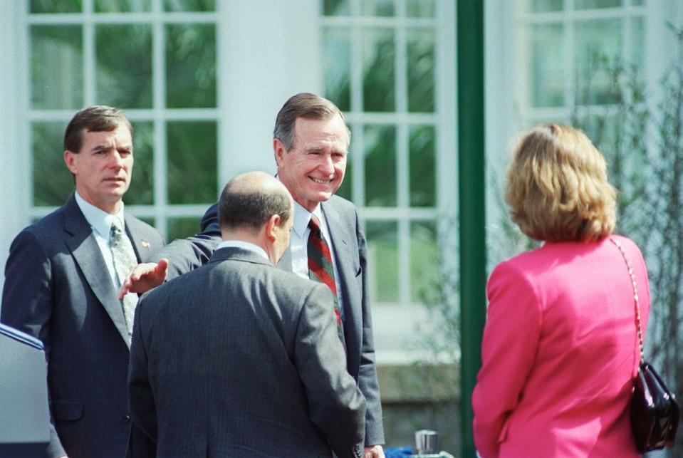 FILE -- John F. Wolfe (center, back to camera) greets President George H. Bush as the President arrives for the opening of AmeriFlora 92 at Franklin Park in Columbus, Ohio on April 20, 1992. (Columbus Dispatch Photo by Doral Chenoweth, III)   George H.W. Bush in Columbus .